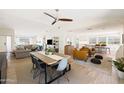 Open dining room with wood table, modern chairs and view into the renovated living area at 2349 E Sahuaro Dr, Phoenix, AZ 85028