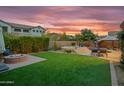 Spacious backyard featuring lush artificial turf, a fire pit, and a spa with lounge chairs at 2454 E Ebony Dr, Chandler, AZ 85286