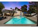 Expansive backyard pool is surrounded by lush greenery and a covered patio, perfect for outdoor entertaining at 25 W Frier Dr, Phoenix, AZ 85021