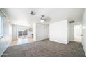 Bright living room with neutral carpet and sliding glass doors to the backyard at 2803 W Angela Dr, Phoenix, AZ 85053