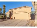 Single-story home showcasing a two-car garage, desert landscaping, and a tile roof at 3055 N Red Mtn # 178, Mesa, AZ 85207