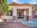 Covered front porch featuring stone pillars and a decorative security screen door at 3129 W Walter Way, Phoenix, AZ 85027