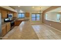 Open kitchen features stainless appliances, wood cabinetry, and ample counter space at 3129 W Walter Way, Phoenix, AZ 85027