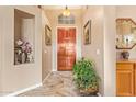 Warm foyer featuring a wood door, neutral walls, and decorative plants and art to create a welcoming space at 3350 W Ivanhoe Ct, Chandler, AZ 85226