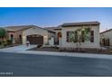 Charming single-story home boasts a gated entrance, manicured landscaping, and a two-car garage at 36276 N Secret Garden Path, Queen Creek, AZ 85140