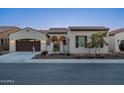 Charming single-story home boasts a gated entrance, manicured landscaping, and a two-car garage at 36276 N Secret Garden Path, Queen Creek, AZ 85140