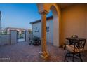 Covered patio showcases neutral columns, tiled flooring, and outdoor seating for relaxed living at 36276 N Secret Garden Path, Queen Creek, AZ 85140