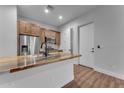 Modern kitchen with stainless steel appliances, unique stone countertop, and contrasting wood and white cabinetry at 38024 N 15Th Ave, Phoenix, AZ 85086