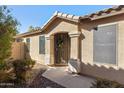 Inviting front entrance featuring a decorative wreath, dog statue, and a secure screen door at 3967 E Hematite Ln, San Tan Valley, AZ 85143