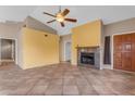 Open living room featuring tile floors, fireplace, and vaulted ceiling with ceiling fan at 4165 W Park Ave, Chandler, AZ 85226