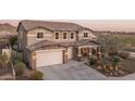 Charming two-story house with a stone-accented three-car garage and a welcoming front porch at 43805 N Ericson Ln, New River, AZ 85087