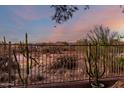 Private backyard with desert landscaping and wrought iron fencing, perfect for enjoying the outdoors at 4546 E Sierra Sunset Trl, Cave Creek, AZ 85331