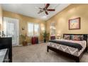 Warm and inviting main bedroom offering lots of natural light, a ceiling fan, and ensuite bathroom at 4546 E Sierra Sunset Trl, Cave Creek, AZ 85331