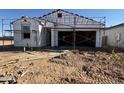 Exterior view of a house in the construction phase showing the initial framing and structure at 47463 W Kenner Dr, Maricopa, AZ 85139