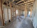 Interior view of a house under construction, showcasing the framing and initial layout of the rooms at 47463 W Kenner Dr, Maricopa, AZ 85139