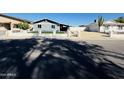 Street view showcasing cozy home with a yard and secure fence for a private outdoor experience at 4836 W Redfield Rd, Glendale, AZ 85306