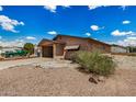 A tan single-story home featuring a front carport, low maintenance desert landscape and ample front yard space at 485 S Pino Cir, Apache Junction, AZ 85120