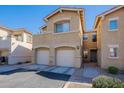 Two-story townhome with a two-car garage, clean driveway and walkway in a community setting at 525 N Miller Rd # 122, Scottsdale, AZ 85257