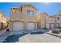 A tan two-story townhome shows off a clean driveway and attached two-car garage at 525 N Miller Rd # 122, Scottsdale, AZ 85257