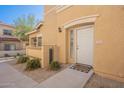 Close up of the front door and entry area of this tan townhome at 525 N Miller Rd # 122, Scottsdale, AZ 85257