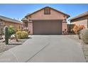 Single level home with a long driveway, desert landscaping, and a two car garage at 8176 S Pioneer Ct, Gold Canyon, AZ 85118