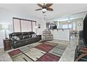 Inviting living room with tile flooring, ceiling fan, and comfortable leather furniture at 8176 S Pioneer Ct, Gold Canyon, AZ 85118