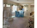 Traditional dining room with glass table, blue chairs, and bright, natural light at 901 W Oriole Way, Chandler, AZ 85286