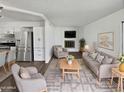 Bright living room features luxury vinyl plank flooring, fireplace, and open layout at 909 W Danbury Rd, Phoenix, AZ 85023