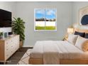 Bright main bedroom featuring vinyl floors, and a large window showcasing the backyard at 909 W Danbury Rd, Phoenix, AZ 85023