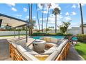 Backyard oasis featuring a covered patio with plush outdoor seating, a fire pit, and a refreshing pool at 10052 N 77Th St, Scottsdale, AZ 85258