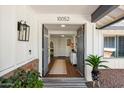 Inviting front entrance featuring double doors, brick accents, and a glimpse into the home's bright interior at 10052 N 77Th St, Scottsdale, AZ 85258