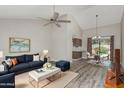 Bright living room with vaulted ceilings, modern furnishings, and an adjacent dining area at 1016 E Utopia Rd, Phoenix, AZ 85024