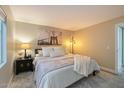 Spacious main bedroom with large bed, carpeted floor, stylish light fixture, and art on the wall at 1016 E Utopia Rd, Phoenix, AZ 85024