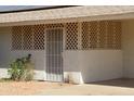 Welcoming front entrance with a decorative security screen door and covered porch area at 10621 N 115Th Ave, Youngtown, AZ 85363