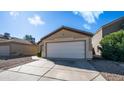 Charming single-story home with a two-car garage, low maintenance landscaping, and a cozy facade at 10851 E Clovis Ave, Mesa, AZ 85208