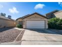Charming single-story home with a two-car garage, low maintenance landscaping, and a cozy facade at 10851 E Clovis Ave, Mesa, AZ 85208