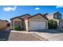 Charming single-story home with a two-car garage, low maintenance landscaping, and a cozy facade at 10851 E Clovis Ave, Mesa, AZ 85208
