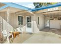 Welcoming front porch with seating area leading to covered parking and additional storage at 10922 W Peoria Ave, Sun City, AZ 85351