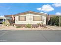 Inviting single-level home featuring a well-maintained exterior and landscaped front yard at 11596 W Sierra Dawn Blvd # 278, Surprise, AZ 85378