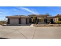 Desert home featuring a multi-car garage, low maintenance landscaping, and neutral colored facade at 12276 N 129Th St, Scottsdale, AZ 85259