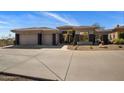 Desert home featuring a multi-car garage, low maintenance landscaping, and neutral colored facade at 12276 N 129Th St, Scottsdale, AZ 85259