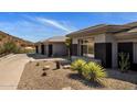 Desert home featuring a multi-car garage, low maintenance landscaping, and mountain views at 12276 N 129Th St, Scottsdale, AZ 85259