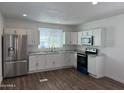 Modern kitchen with stainless steel appliances, granite countertops, and ample cabinet space at 12814 N 19Th Pl # 19, Phoenix, AZ 85022