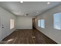 Spacious living room featuring new wood-look floors, neutral paint, and a ceiling fan at 12814 N 19Th Pl # 19, Phoenix, AZ 85022
