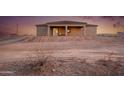 Rear view of a single-story home featuring a covered patio and simple landscaping at 12942 S 218Th Ave, Buckeye, AZ 85326