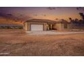 Inviting home featuring a neutral stucco exterior, tile roof, and simple landscaping at 12942 S 218Th Ave, Buckeye, AZ 85326