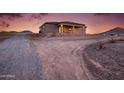 Lovely backyard view of the neutral stucco home highlighting a covered patio at 12942 S 218Th Ave, Buckeye, AZ 85326