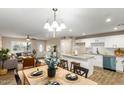 Bright open floor plan with a modern kitchen, granite counters, stainless steel appliances, and breakfast bar at 14436 N 34Th Pl, Phoenix, AZ 85032
