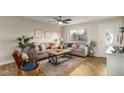 Comfortable living room with a large window, ceiling fan, and contemporary decor, perfect for relaxation at 14436 N 34Th Pl, Phoenix, AZ 85032