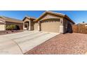 Charming single story home with a two car garage and well maintained desert landscaping at 14846 N 145Th Ave, Surprise, AZ 85379